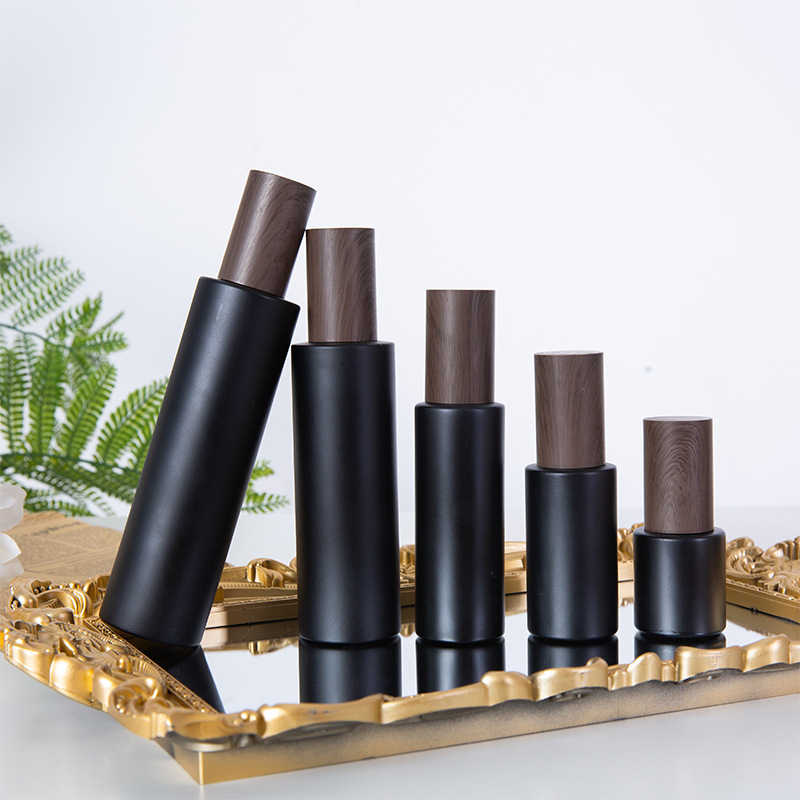 Cosmetics Packaging Custom Luxury Black Glass Bottle with Wooden Cover Oil Pump Bottle Cosmetic Serum Hair Care Packaging Set